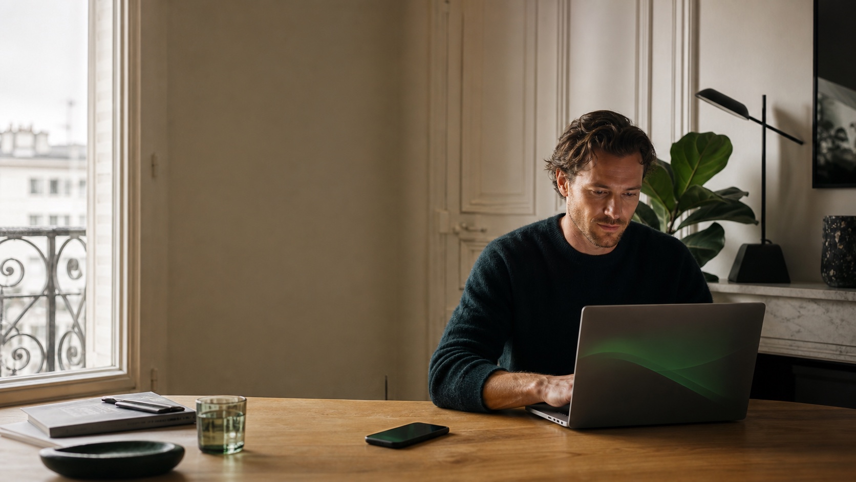 A calm home workspace with a laptop and phone